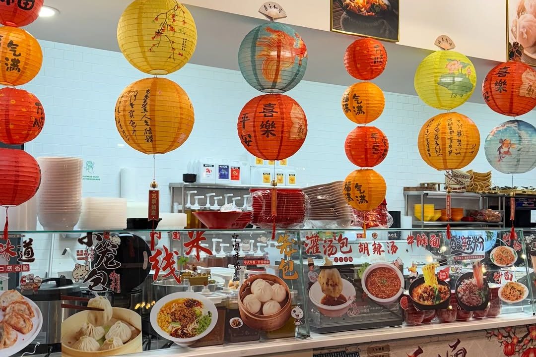 Colorful paper lanterns and food photos inside Kawaii Tea Time in Omaha