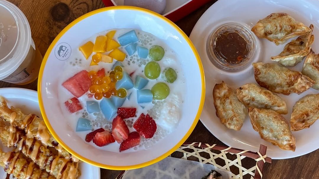 A fruit sago bowl, pan-fried dumplings and a drink on a table at Kawaii Tea Time