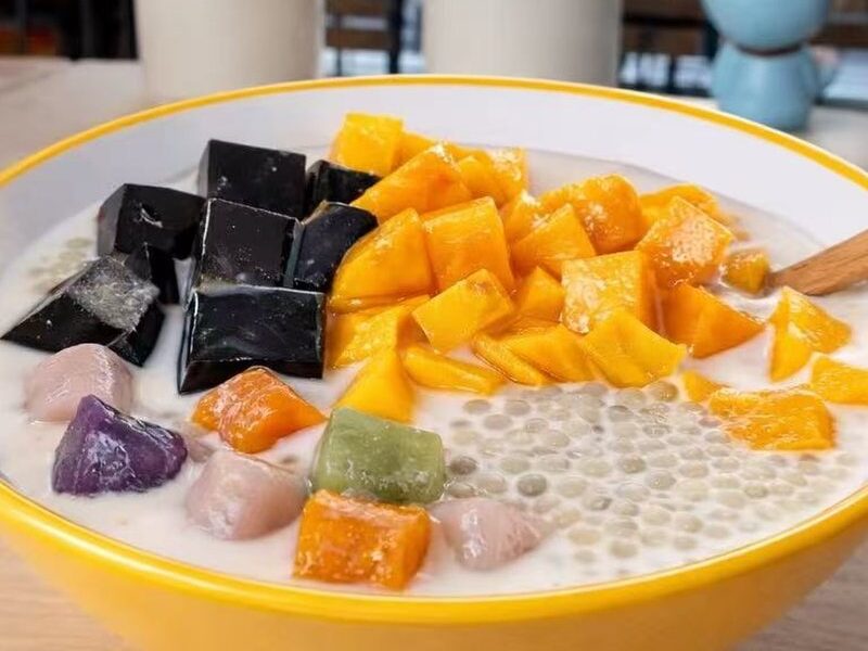 A coconut sago dessert bowl with mango, grass jelly and taro balls